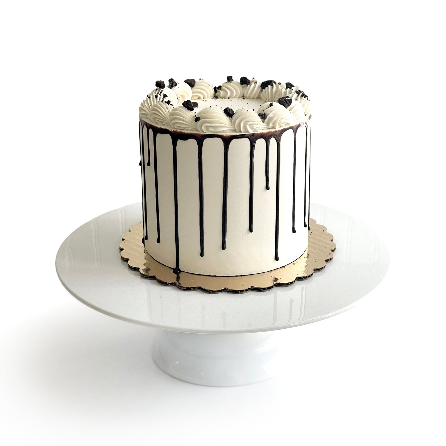 Double Vanilla & Chocolate Cake filled w/ Cookies and Cream covered w/ White Chocolate Ganache