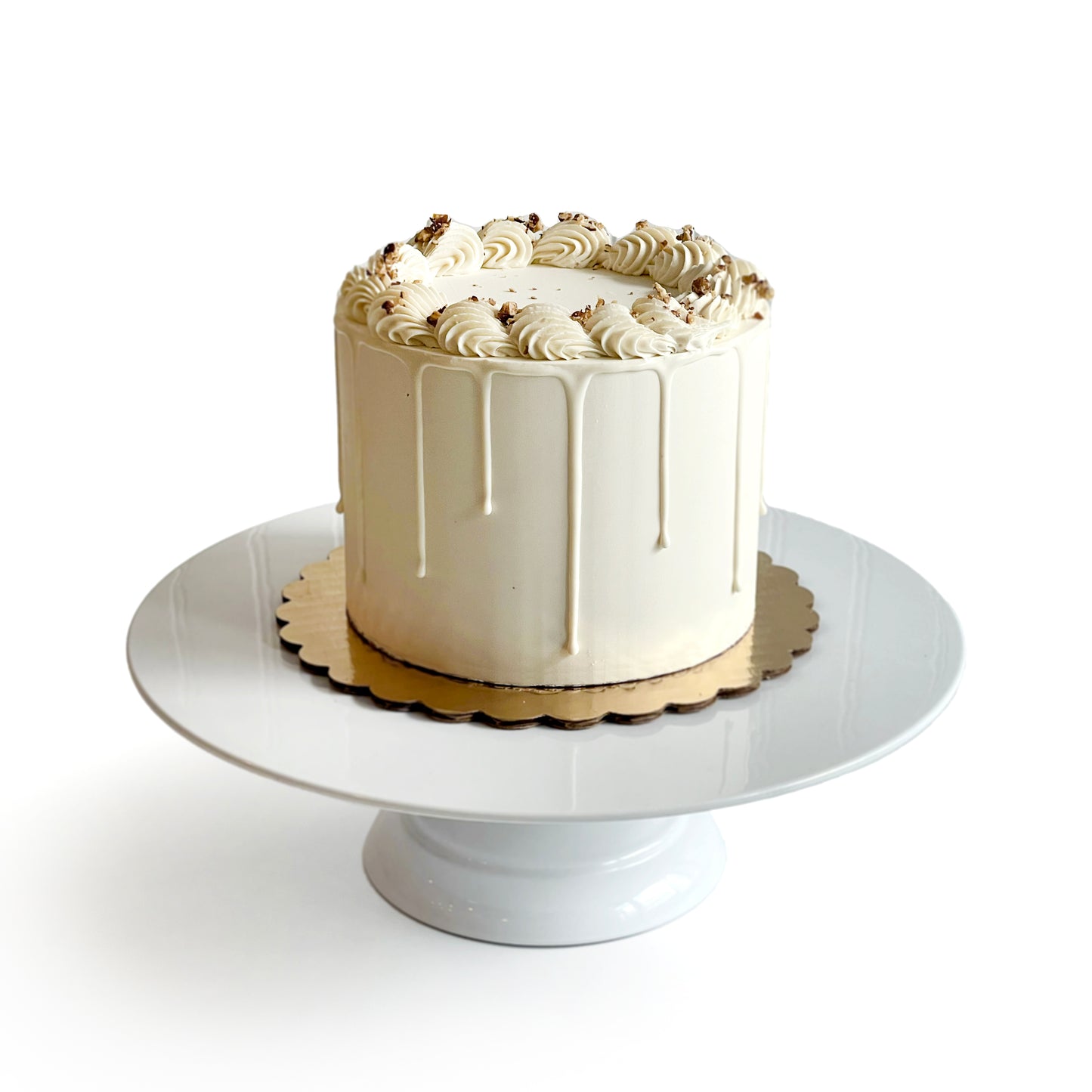 Double Vanilla Cake filled w/ Almond Praline Cream Cheese Buttercream covered w/ White Chocolate Ganache